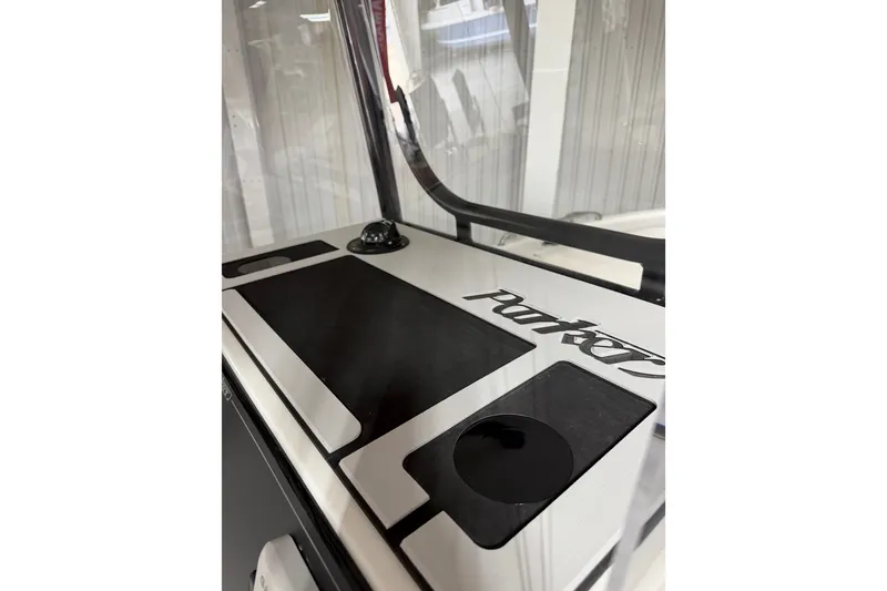 Slide: The Image of 2027 Parker 220 Coastal Elite boat dashboard with logo and cup holders. - 16