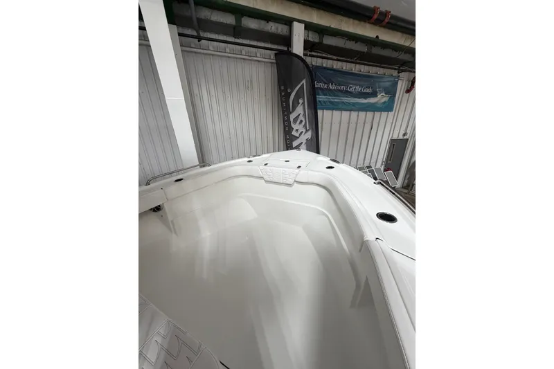 Slide: The Image of 2027 Parker 220 Coastal Elite boat interior in showroom setting. - 17