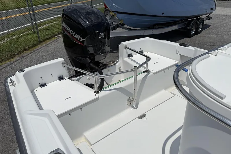 Slide: The Image of 1996 Boston Whaler Outrage 17 boat interior with Mercury outboard motor. - 7