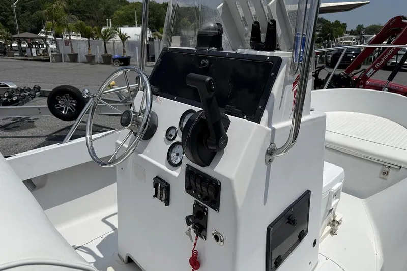 Slide: The Image of 1996 Boston Whaler Outrage 17 boat console with steering wheel and controls. - 4