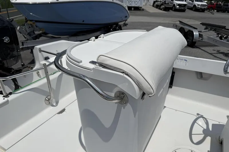 Slide: The Image of 1996 Boston Whaler Outrage 17 boat interior with white cushioned seating and steering wheel. - 6