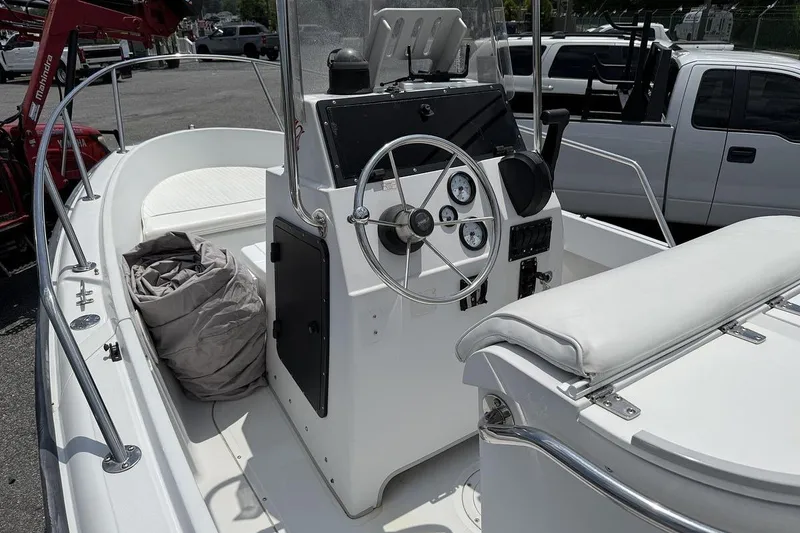 Slide: The Image of 1996 Boston Whaler Outrage 17 boat interior with steering console and seating. - 8