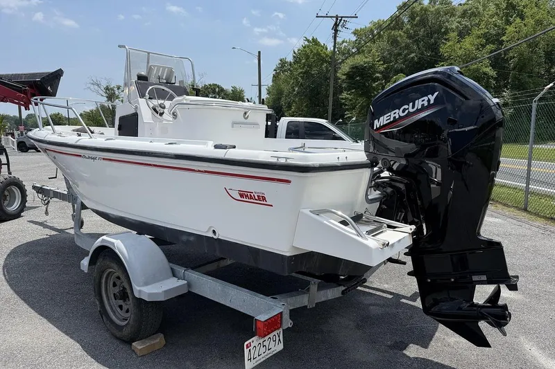 Slide: The Image of 1996 Boston Whaler Outrage 17 boat on trailer with Mercury outboard motor. - 3