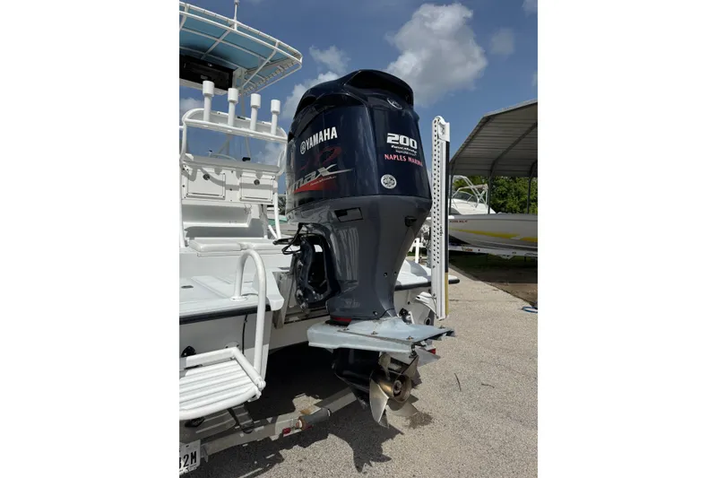 Slide: The Image of 2012 Shallow Sport 21 Modified V boat with Yamaha 200 outboard motor in marina setting. - 4