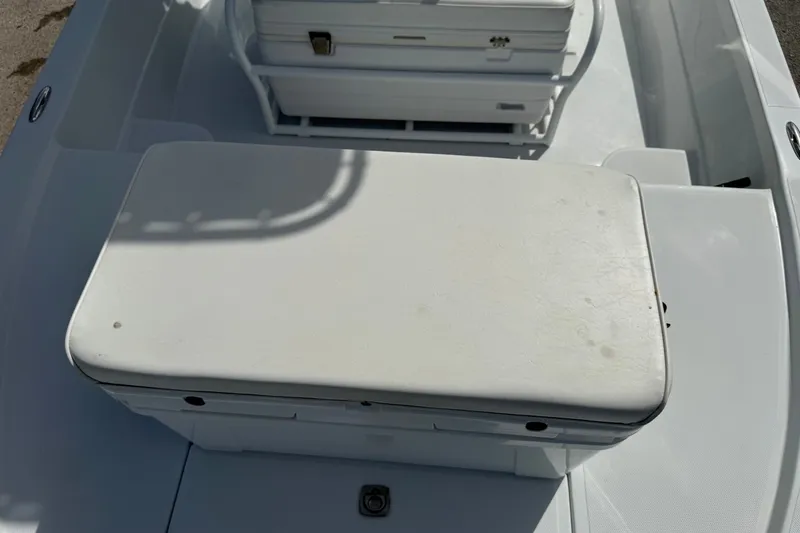 Slide: The Image of 2012 Shallow Sport 21 Modified V boat interior with white seating and storage. - 29