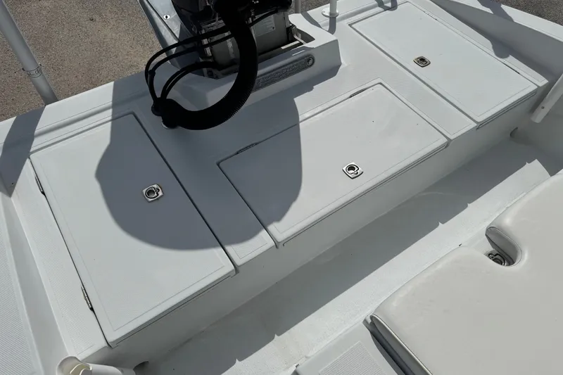 Slide: The Image of 2012 Shallow Sport 21 Modified V boat deck with storage compartments and seating. - 7