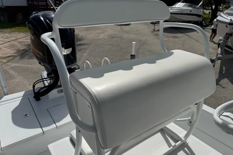 Slide: The Image of 2012 Shallow Sport 21 Modified V boat with cushioned seating and Yamaha outboard motor. - 22