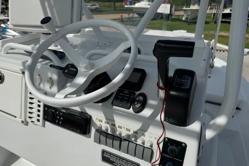 Slide: The Image of 2012 Shallow Sport 21 Modified V boat console with steering wheel and controls. - 20
