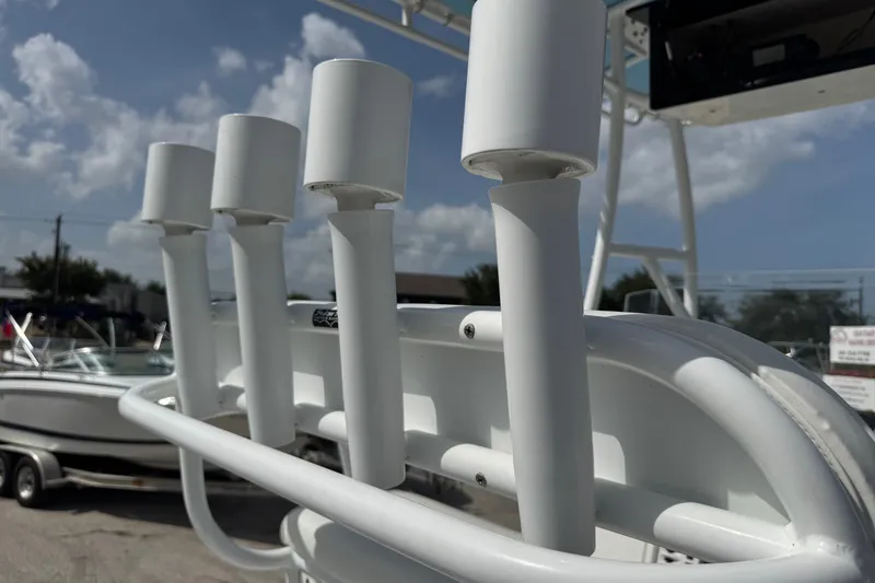 Slide: The Image of Rod holders on a 2012 Shallow Sport 21 Modified V boat under a clear sky. - 17