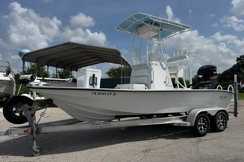 The Image of 2012 Shallow Sport 21 Modified V boat on trailer under cloudy sky. - 0