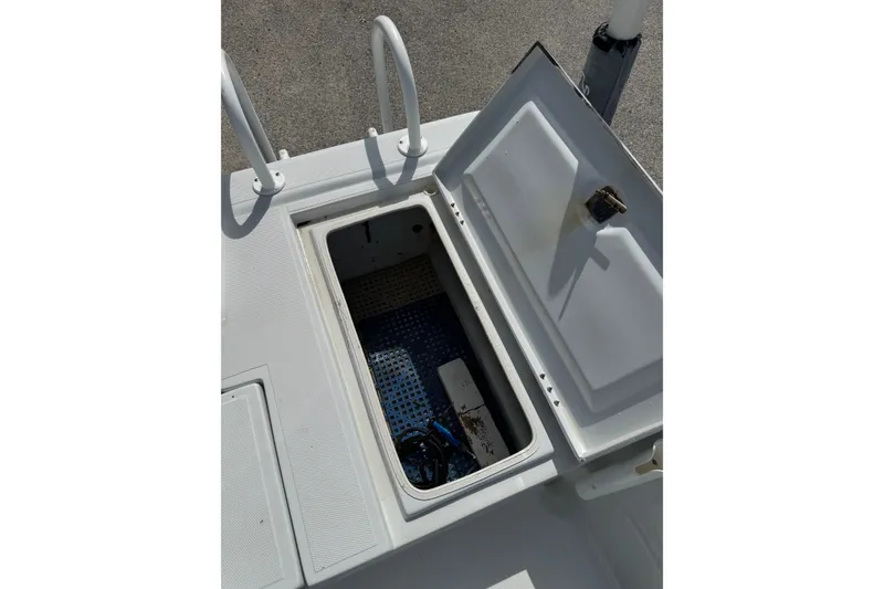 Slide: The Image of Open storage compartment on a 2012 Shallow Sport 21 Modified V boat deck. - 11