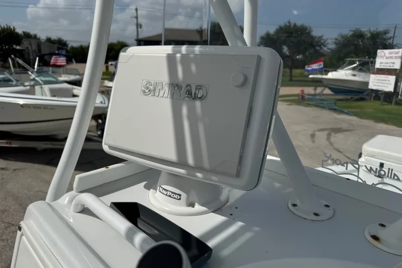 Slide: The Image of Simrad navigation system on 2012 Shallow Sport 21 Modified V boat, docked with other boats. - 21