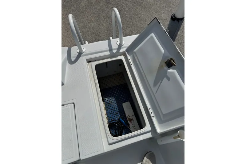Slide: The Image of Open storage compartment on a 2012 Shallow Sport 21 Modified V boat deck. - 10