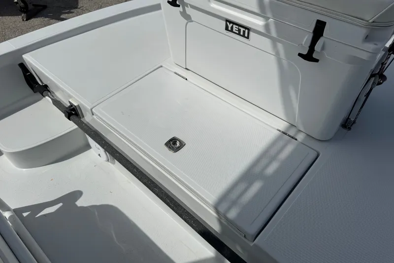 Slide: The Image of 2012 Shallow Sport 21 Modified V boat deck with Yeti cooler, featuring storage compartment. - 26