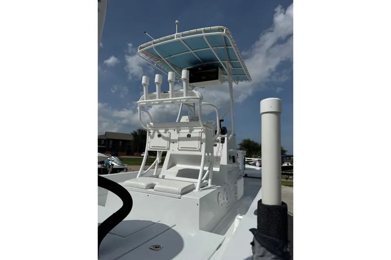 Slide: The Image of 2012 Shallow Sport 21 Modified V boat with T-top under a clear blue sky. - 6