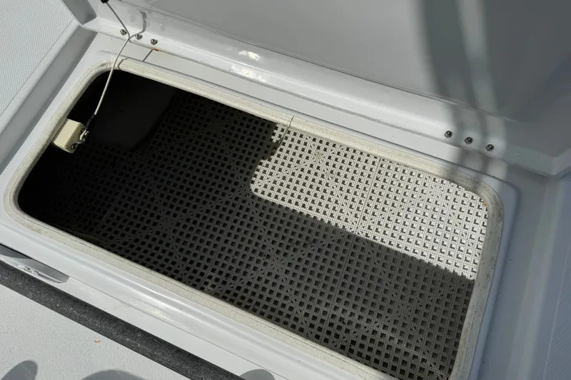 Slide: The Image of Open storage compartment on a 2012 Shallow Sport 21 Modified V boat. - 27