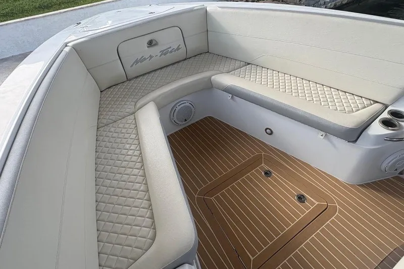Slide: The Image of Luxurious seating area on a 2014 Nor-Tech 390 Sport boat with quilted upholstery. - 6