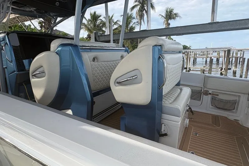 Slide: The Image of Interior of a 2014 Nor-Tech 390 Sport boat with luxurious seating and scenic marina view. - 8