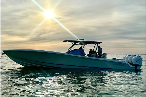 Slide: The Image of 2014 Nor-Tech 390 Sport boat cruising on calm waters at sunset. - 2