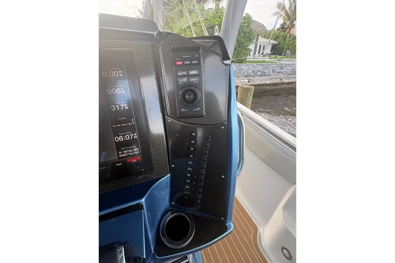 Slide: The Image of Dashboard of 2014 Nor-Tech 390 Sport boat with navigation controls and display. - 13