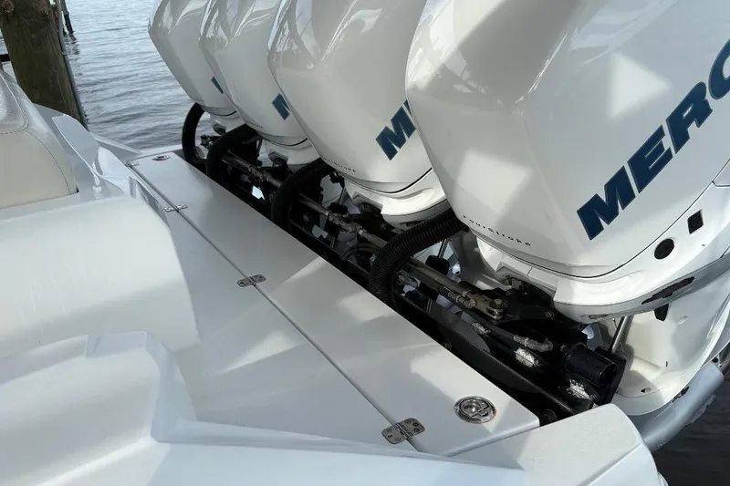 Slide: The Image of 2014 Nor-Tech 390 Sport boat with multiple Mercury outboard engines, docked by the water. - 16