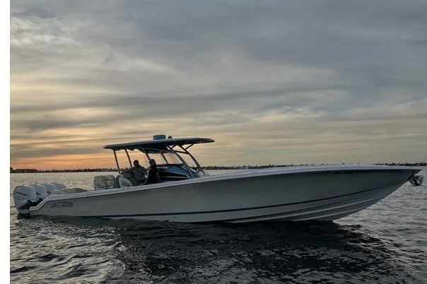 The Image of 2014 Nor-Tech 390 Sport boat cruising on water at sunset. - 0