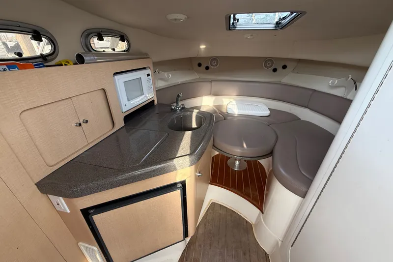 Slide: The Image of Interior of 2000 Boston Whaler 28 Conquest boat with kitchenette and seating area. - 13