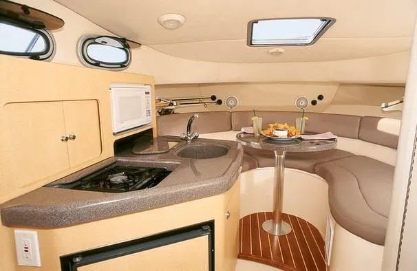 Slide: The Image of Interior of a 2000 Boston Whaler 28 Conquest with a kitchenette and seating area. - 21