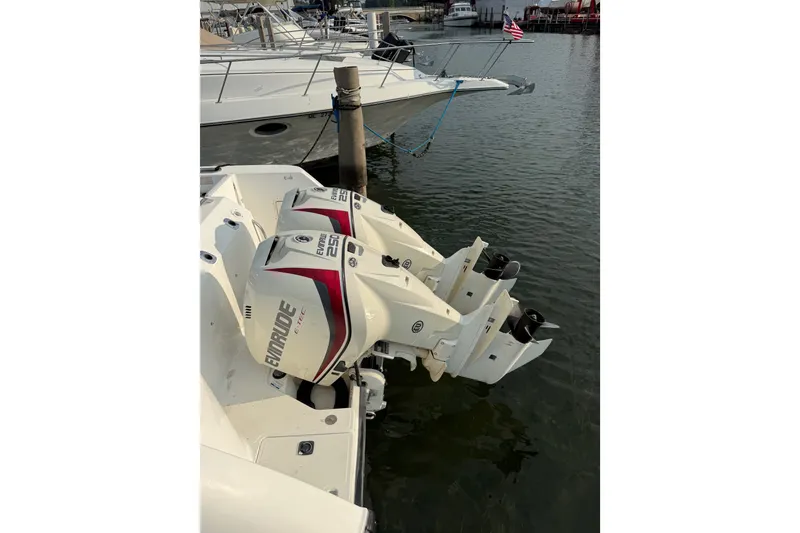 Slide: The Image of Boston Whaler 28 Conquest 2000 with twin Evinrude 250 engines docked in marina. - 3
