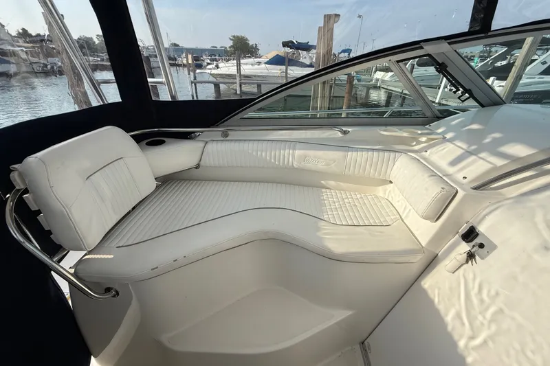 Slide: The Image of Interior seating of a 2000 Boston Whaler 28 Conquest boat at a marina. - 10
