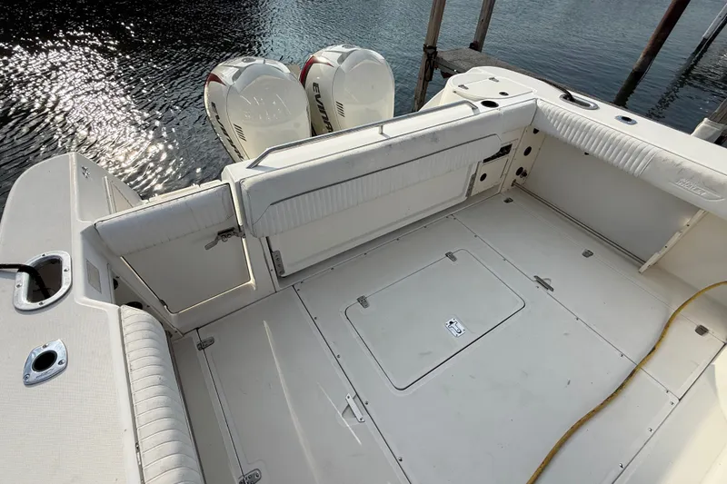 Slide: The Image of Boston Whaler 28 Conquest 2000 boat deck with twin engines and seating area. - 4