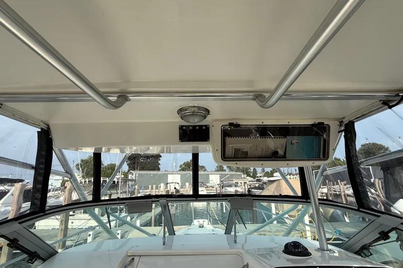 Slide: The Image of Interior view of a 2000 Boston Whaler 28 Conquest boat cockpit with clear windows. - 9