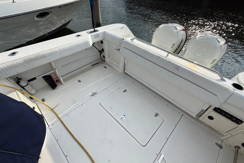 Slide: The Image of Boston Whaler 28 Conquest 2000 boat deck with seating and twin outboard engines. - 5