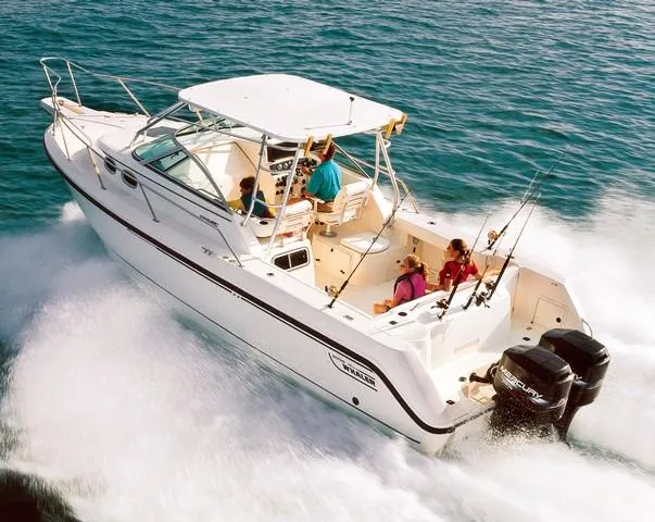 Slide: The Image of A 2000 Boston Whaler 28 Conquest speeds across the water with several people on board. - 19