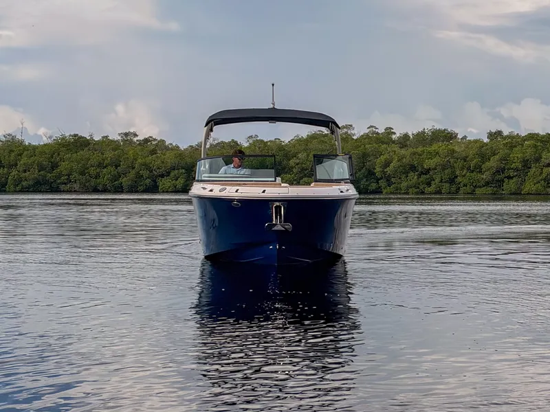 Slide: The Image of A 2027 Sea Ray SDX 270 Outboard on calm water with a cloudy sky. - 4