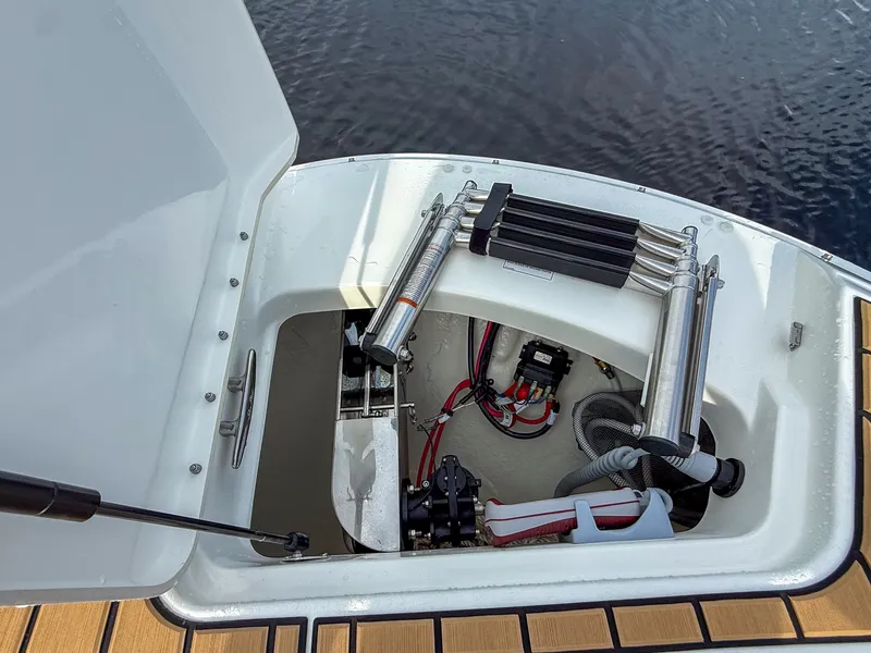 Slide: The Image of An open storage compartment on a Sea Ray SDX 270 Outboard boat. - 17