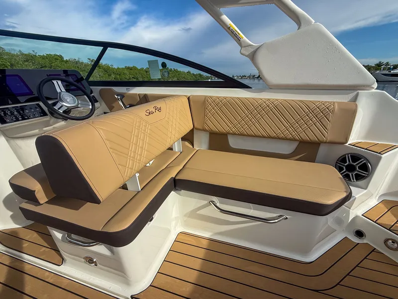 Slide: The Image of The image shows the interior of a Sea Ray SDX 270 Outboard with elegant brown upholstery and a modern helm. - 11