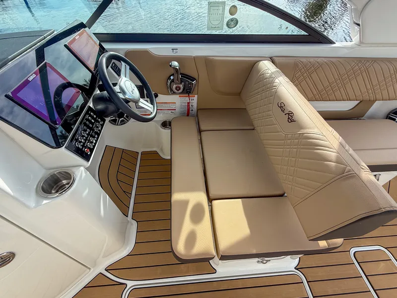 Slide: The Image of The cockpit of the 2027 Sea Ray SDX 270 Outboard features modern design with beige upholstery. - 10