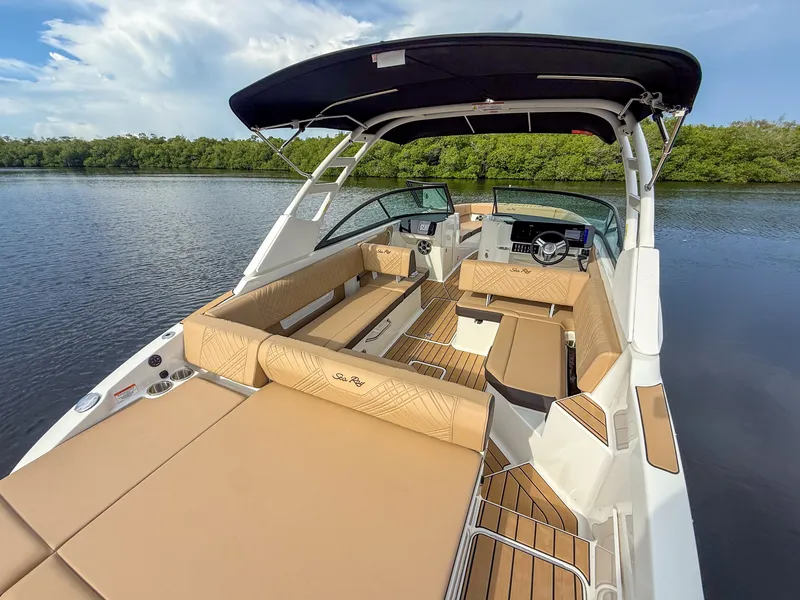 Slide: The Image of The image shows a Sea Ray SDX 270 Outboard boat with sleek seating and a modern helm. - 6