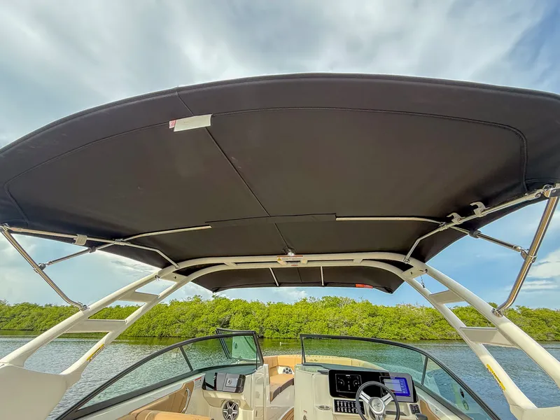 Slide: The Image of The image shows the cockpit of a Sea Ray SDX 270 Outboard with a black sunshade. - 8