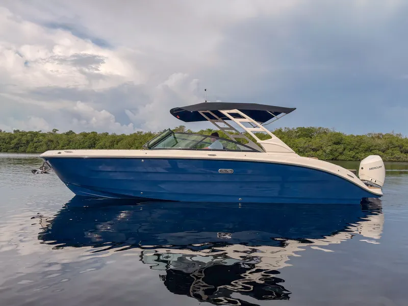 Slide: The Image of A sleek blue 2027 Sea Ray SDX 270 Outboard boat on calm water. - 1