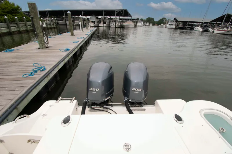 Slide: The Image of 2016 NauticStar 28 XS boat with twin Yamaha 200 engines docked at marina. - 16