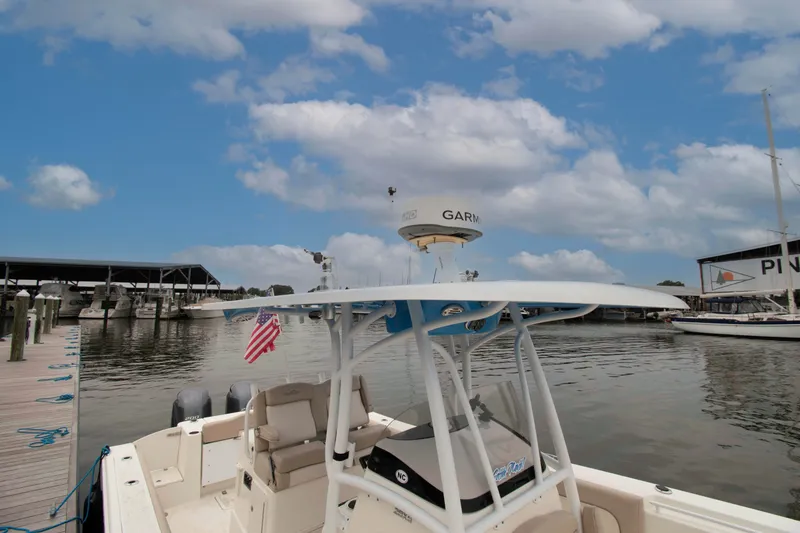 Slide: The Image of 2016 NauticStar 28 XS boat docked at marina under blue sky. - 14