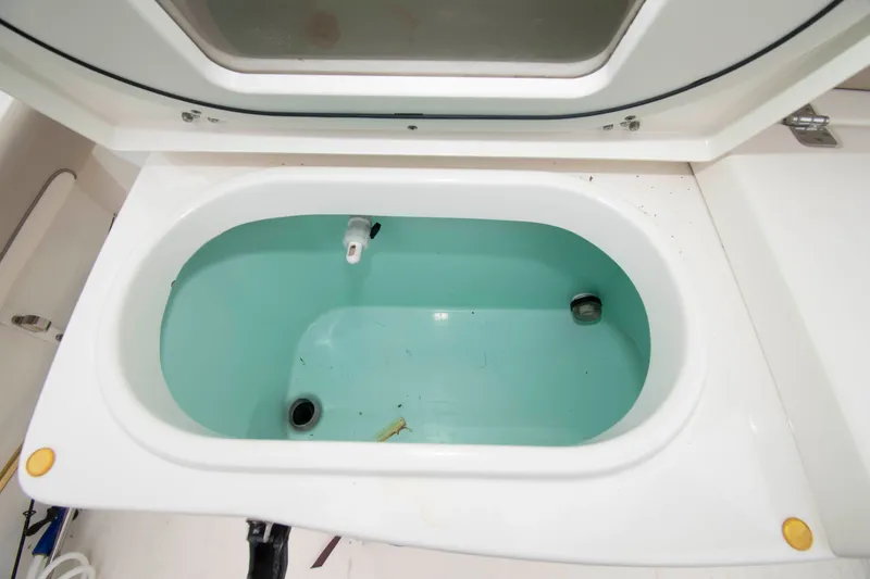 Slide: The Image of Open livewell compartment on 2016 NauticStar 28 XS boat, showcasing interior details. - 17