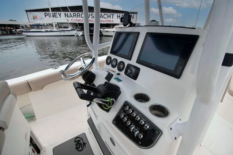 Slide: The Image of 2016 NauticStar 28 XS boat dashboard with dual screens at Piney Narrows Yacht Haven. - 3