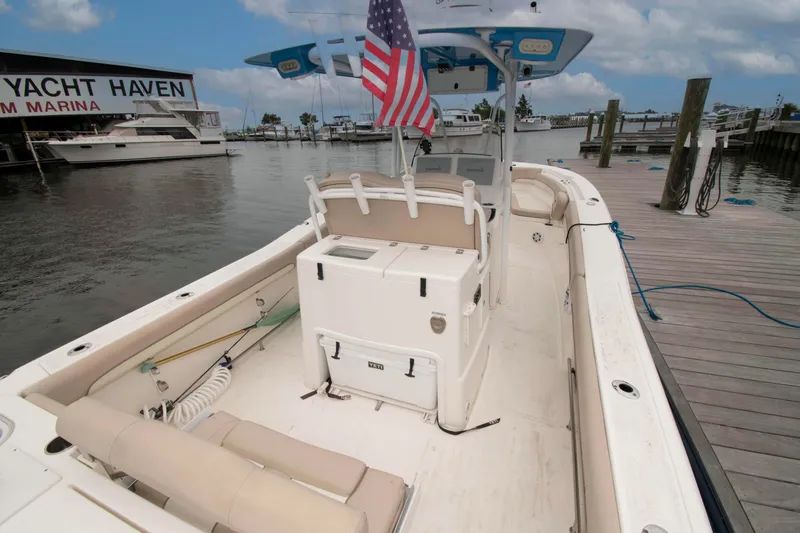 Slide: The Image of 2016 NauticStar 28 XS boat docked at marina with American flag. - 9