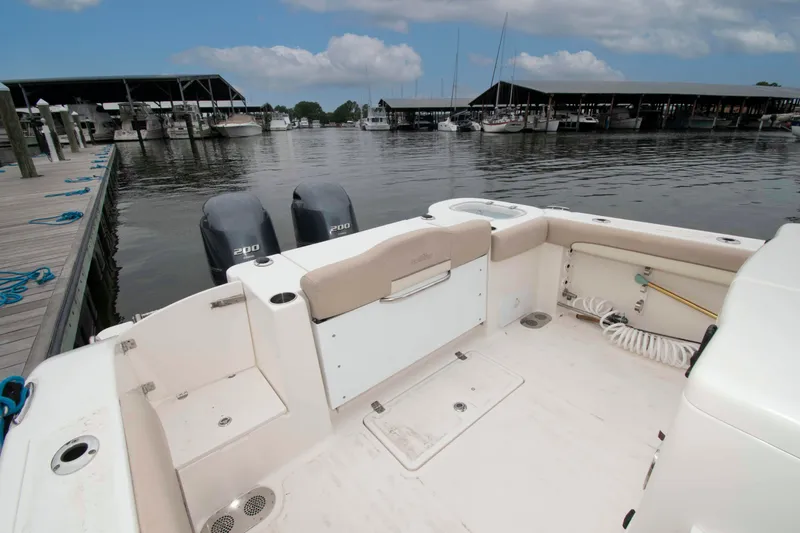 Slide: The Image of 2016 NauticStar 28 XS boat docked, featuring dual 200 horsepower engines. - 13