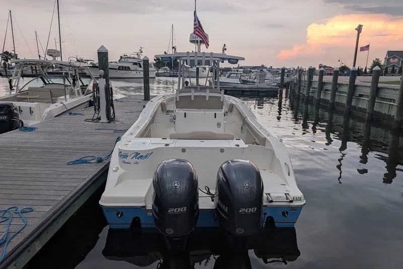 Slide: The Image of 2016 NauticStar 28 XS boat docked at marina with twin Yamaha engines. - 15