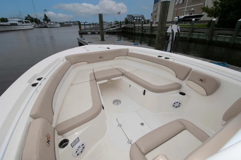Slide: The Image of 2016 NauticStar 28 XS boat with spacious seating at a marina dock. - 7