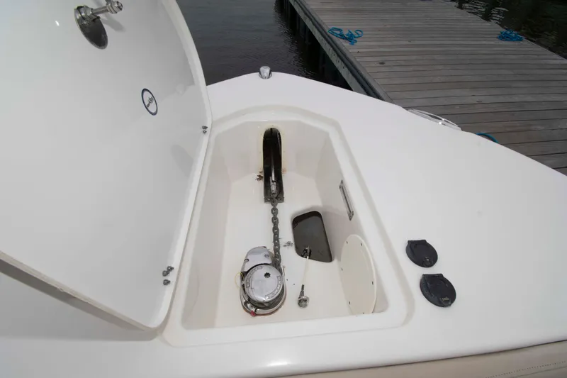 Slide: The Image of 2016 NauticStar 28 XS anchor compartment with open hatch, dockside view. - 18